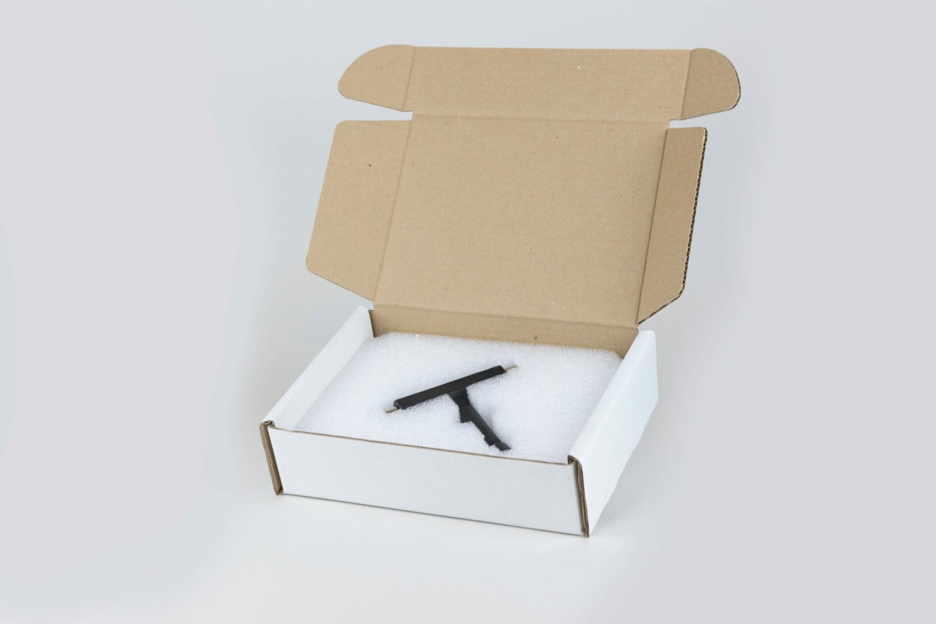 Open box with foam packaging inside.